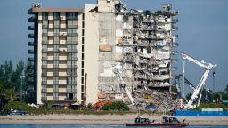 Coast guard boats patrol in front of the partially collapsed Champlain Towers South condo building, ahead of a planned visit to the site by President Joe Biden, on Thursday, July 1, 2021, in Surfside, Fla. Search and rescue workers, who have had to contend with summer rainstorms, fires within the debris, and the threat of collapse from the still standing portion of the building, were not visible atop the rubble on Thursday morning, as scores of people remain missing one week after the collapse.(AP Photo/Mark Humphrey)