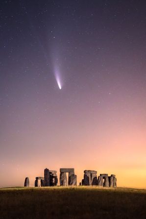 The comet NEOWISE can be seen passing over Stonehenge in the United Kingdom.