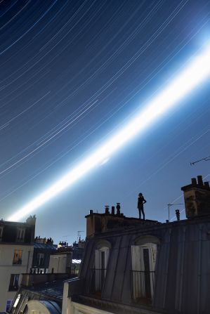These roofs look out onto the photographer's flat in the center of Paris, and the image tracks the moon's trajectory.