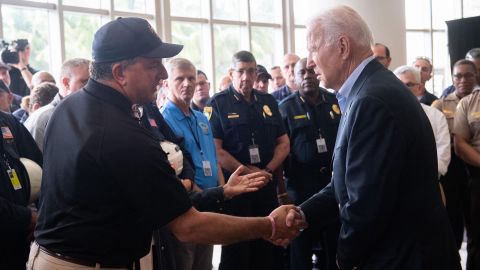 US President Joe Biden(R) shakes hands with Jimmy Patronis, Florida's Chief Financial Officer, as he meets with first responders to the collapse of the 12-story Champlain Towers South condo building in Surfside, during a meeting with them in Miami Beach, Florida, July 1, 2021. - President Joe Biden flew to Florida on Thursday to "comfort" families of people killed or still missing in the rubble of a beachfront apartment building, where hopes of finding survivors had all but evaporated. Biden and First Lady Jill Biden left the White House early for the flight to Miami, and then traveled by motorcade to nearby Surfside, where the death toll in the tragedy now stands at 18, and more than 140 still unaccounted for. (Photo by SAUL LOEB/AFP via Getty Images)