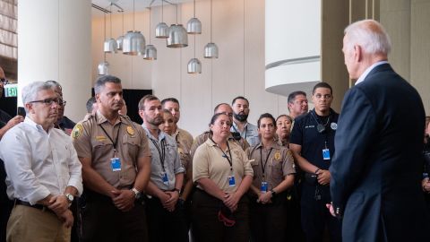 US President Joe Biden greets first responders to the collapse of the 12-story Champlain Towers South condo building in Surfside, during a meeting with them in Miami Beach, Florida, July 1, 2021. - President Joe Biden flew to Florida on Thursday to "comfort" families of people killed or still missing in the rubble of a beachfront apartment building, where hopes of finding survivors had all but evaporated. Biden and First Lady Jill Biden left the White House early for the flight to Miami, and then traveled by motorcade to nearby Surfside, where the death toll in the tragedy now stands at 18, and more than 140 still unaccounted for. (Photo by SAUL LOEB / AFP) (Photo by SAUL LOEB/AFP via Getty Images)