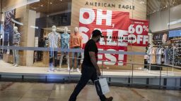 A shopper wearing a protective mask walks past a sale sign at an American Eagle Outfitters Inc. clothing store at Westfield San Francisco Centre in San Francisco, California, U.S., on Thursday, June 18, 2020.