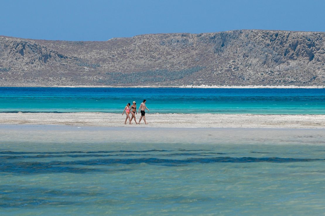 Tourists walk on the Balos beach and lagoon in Crete in May.