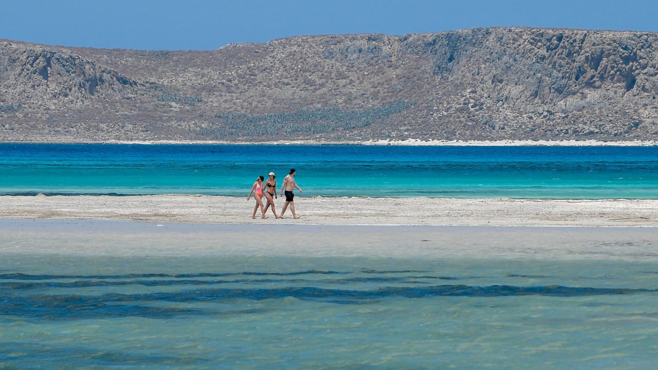Tourists walk on the Balos beach and lagoon in Crete in May.