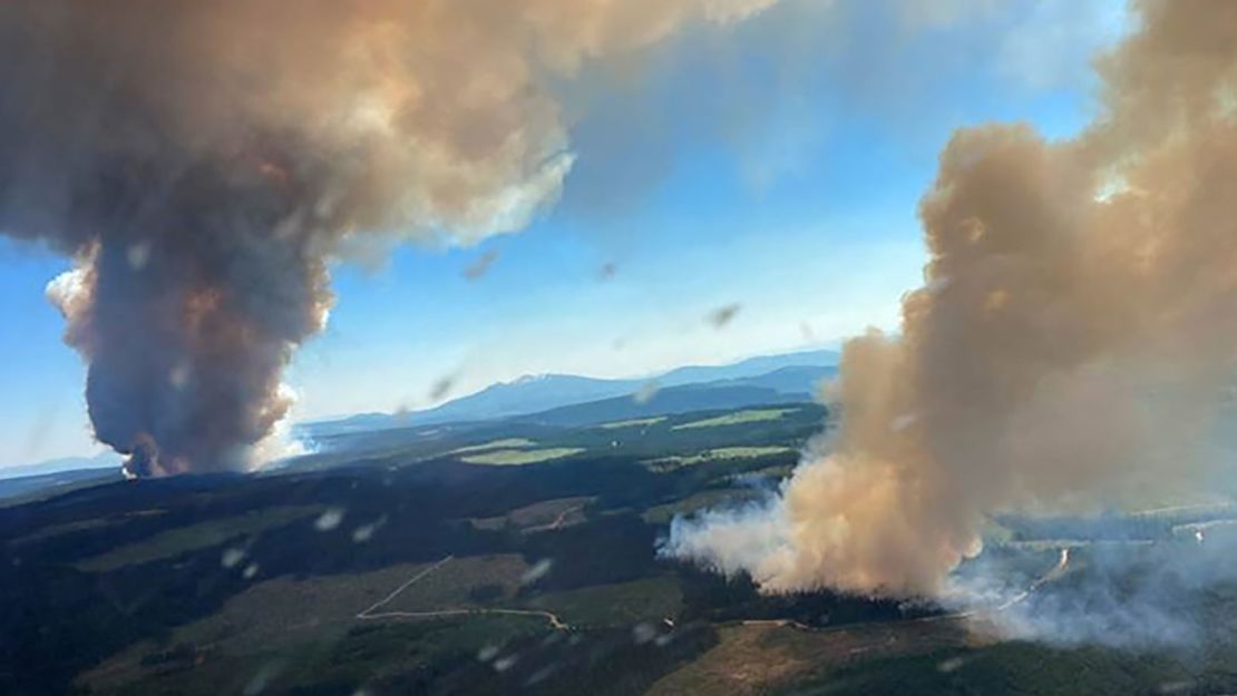 Smoke rises from a fire at Long Loch and Derrickson Lake in Central Okanagan in Canada on June 30.