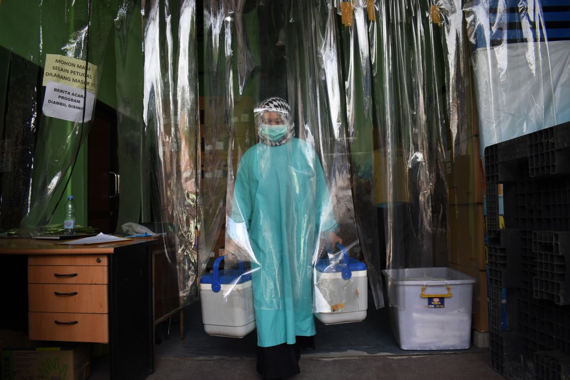 A health worker delivers containers of Sinovac vaccines from a cold room in Bandung, Indonesia.