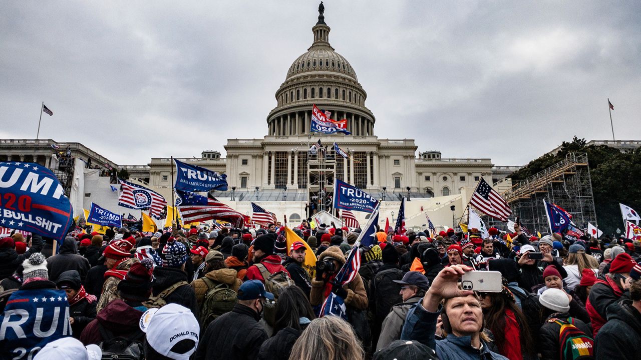Pro-Trump supporters storm the US Capitol following a rally with President Donald Trump on January 6, 2021 in Washington, DC. (Photo by Samuel Corum/Getty Images)