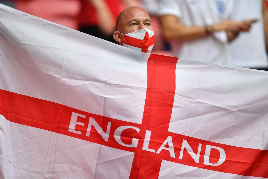 An England supporter waves a flag ahead of the start of the Euro 2020 match between England and Germany.