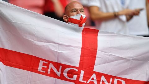 An England supporter waves a flag ahead of the start of the Euro 2020 match between England and Germany.