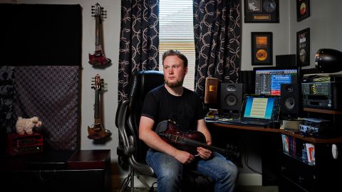 Kyle Pudenz, a violinist, songwriter and arranger, sits in his home studio, where he was able to livestream performances, write and compose music after the pandemic shut down live events.