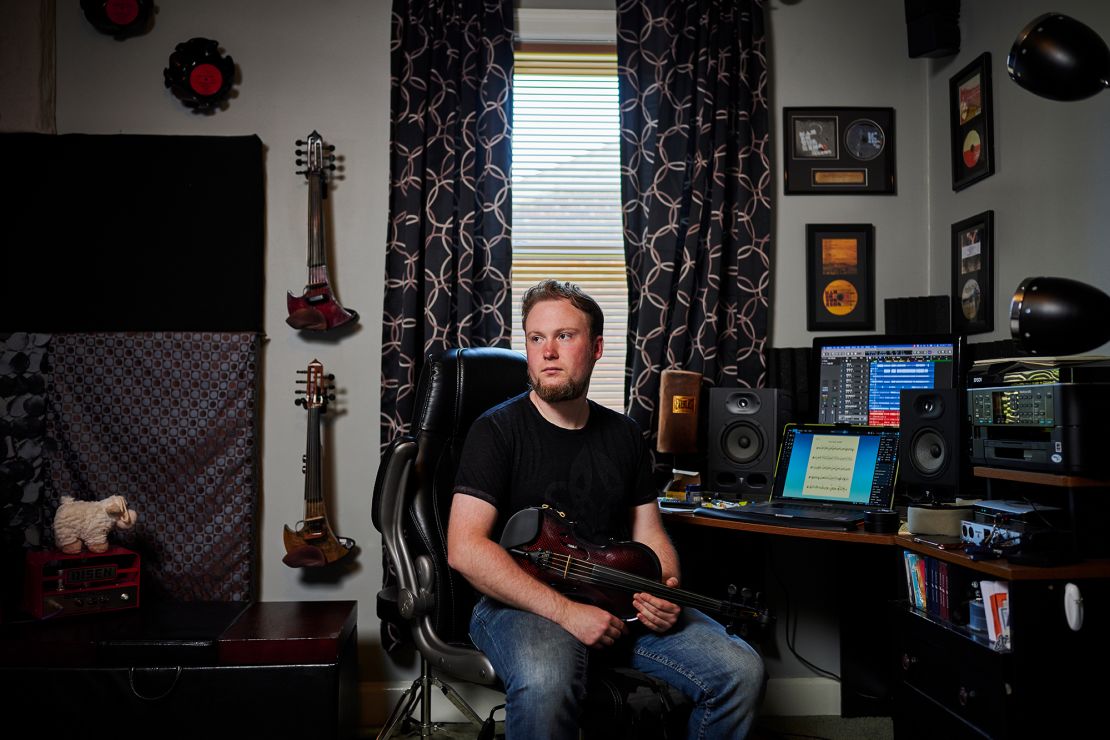 Kyle Pudenz, a violinist, songwriter and arranger, sits in his home studio, where he was able to livestream performances, write and compose music after the pandemic shut down live events.