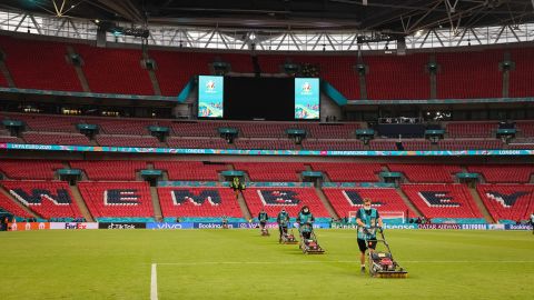 Groundkeepers work on the grass at Wembley Stadium after a match.