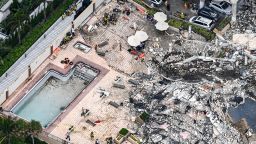 This aerial view, shows search and rescue personnel working on site after the partial collapse of the Champlain Towers South in Surfside, north of Miami Beach, on June 24, 2021. - The multi-story apartment block in Florida partially collapsed early June 24, sparking a major emergency response. Surfside Mayor Charles Burkett told NBCs Today show: My police chief has told me that we transported two people to the hospital this morning at least and one has died. We treated ten people on the site. (Photo by CHANDAN KHANNA / AFP) (Photo by CHANDAN KHANNA/AFP via Getty Images)