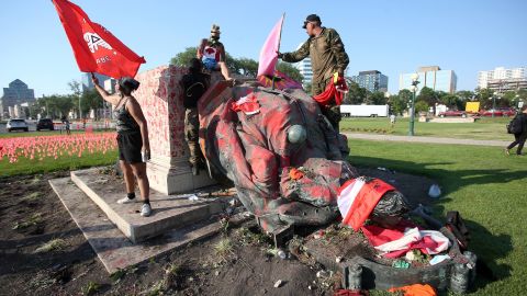 A crowd chanted "no pride in genocide" before pulling down the statues.