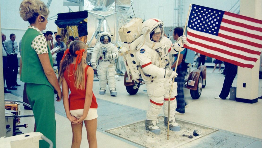 Tracy Cernan (red shirt) and her mother watch her astronaut father, Gene, deploy the American flag during training in August 1972, several months before the Apollo 17 mission.