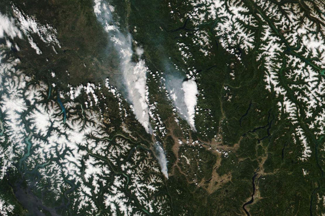 A handout satellite image made available by NASA shows the McKay Creek fire, left, the Sparks Lake fire, right, and a smaller fire at bottom, visible just south of Lytton, British Columbia, on Wednesday, June 30.
