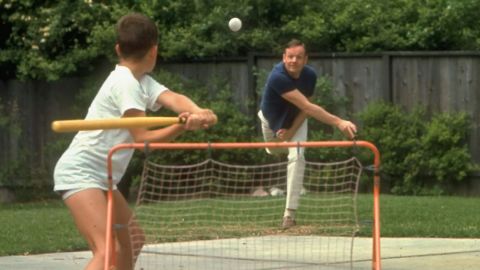 Neil Armstrong pitches a ball to his son, Rick, at their home in March 1969. The Armstrong boys often used their backyard as a wiffle ball field, but despite this image, "in reality (dad) wasn't in the lineup much," Rick said.