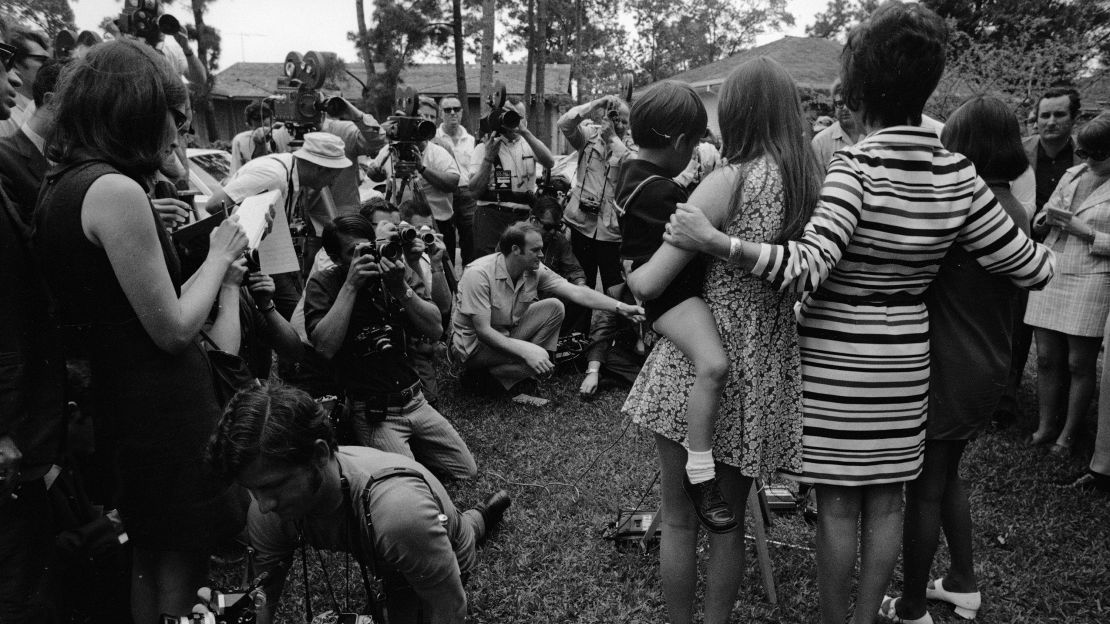 Barbara Lovell and her mother, Marilyn, and siblings, Jeffrey and Susan, face the mass gathering of press in their front lawn following the successful return of the Apollo 13 crew, April 1970.