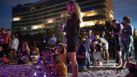 People join together in a community twilight vigil on the beach for those lost and missing during the partially collapsed Champlain Towers South condo building on June 28, 2021 in Surfside, Florida.