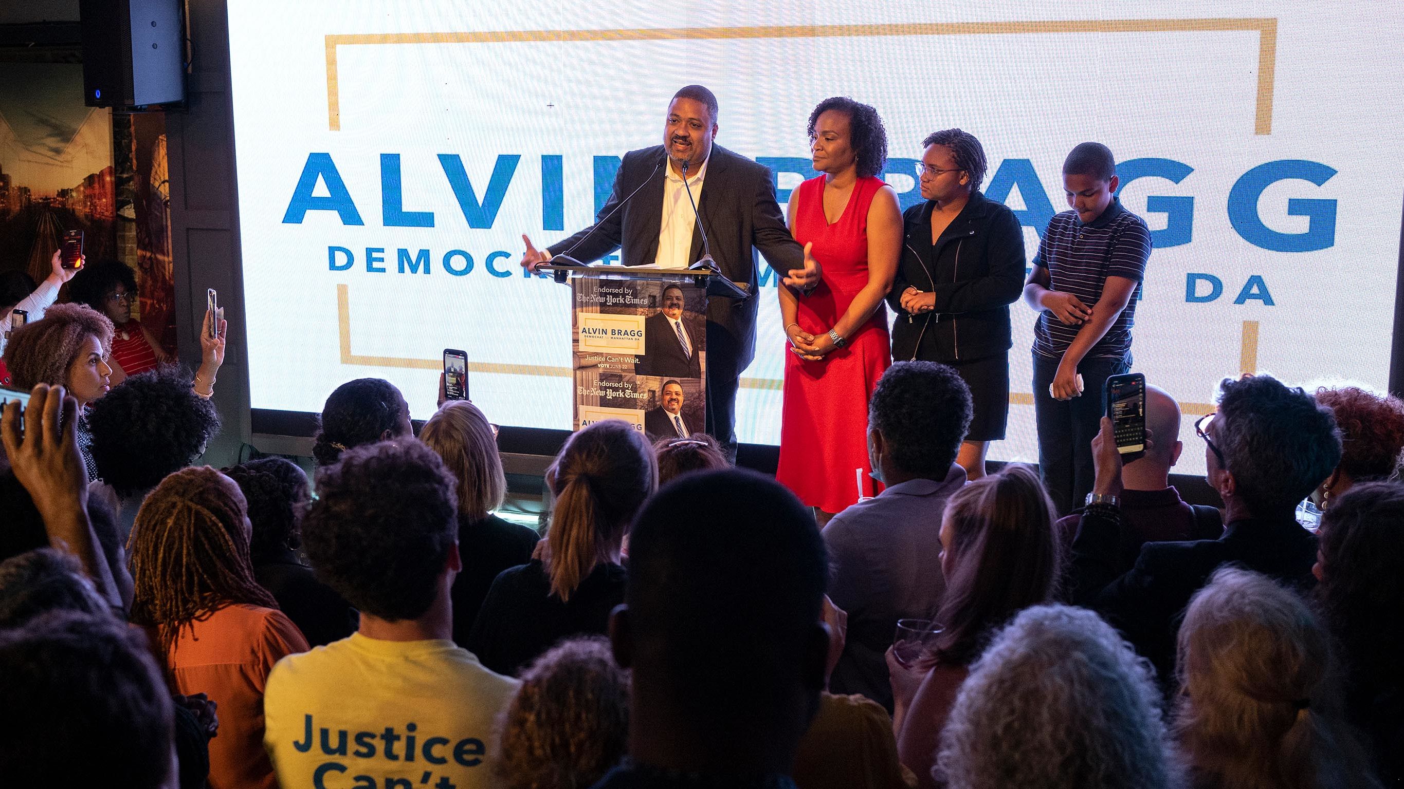Alvin Bragg, a former top deputy to New York's attorney general, stands with his family as he speaks to supporters in New York, late Tuesday, June 22, 2021. 