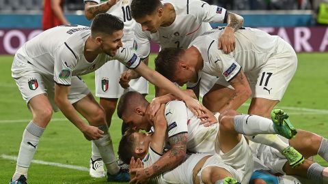 Nicolo Barella is mobbed by his teammates after scoring Italy's opening goal.