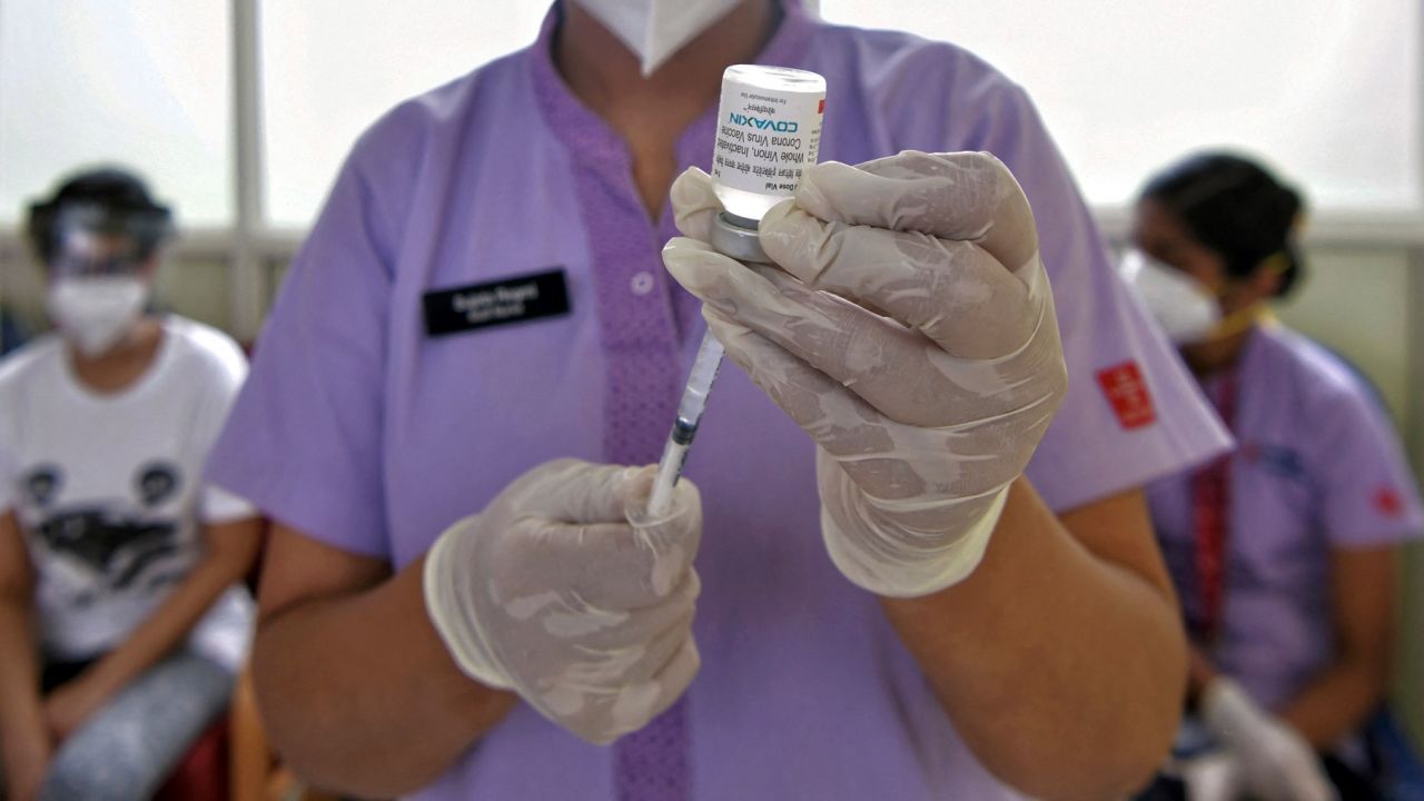 A nurse prepares to inoculate a man with a dose of the Covaxin vaccine in Manipal Hospital in Bangalore on June 18, 2021.