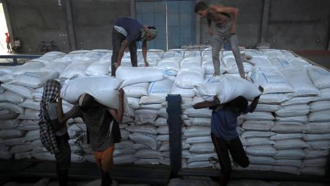 Ethiopian porters unload food aid bound for victims of war after a checkpoint leading to Tigray in Mai Tsebri town, Ethiopia June 26.