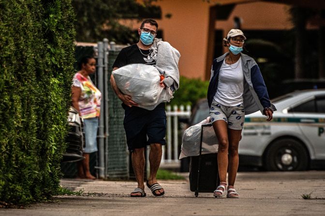 Residents of the Crestview Towers Condominium carry their belongings <a href="index.php?page=&url=https%3A%2F%2Fwww.cnn.com%2F2021%2F07%2F02%2Fus%2Fnorth-miami-crestview-condo-building-ordered-closed%2Findex.html" target="_blank">as they leave their building </a>in North Miami Beach, Florida, on July 2. The building, about 6 miles from Surfside, was deemed to be structurally and electrically unsafe based on a delinquent recertification report for the almost 50-year-old building. The city said the move was out of an "abundance of caution," as area authorities check high-rise condo buildings following the Surfside collapse.
