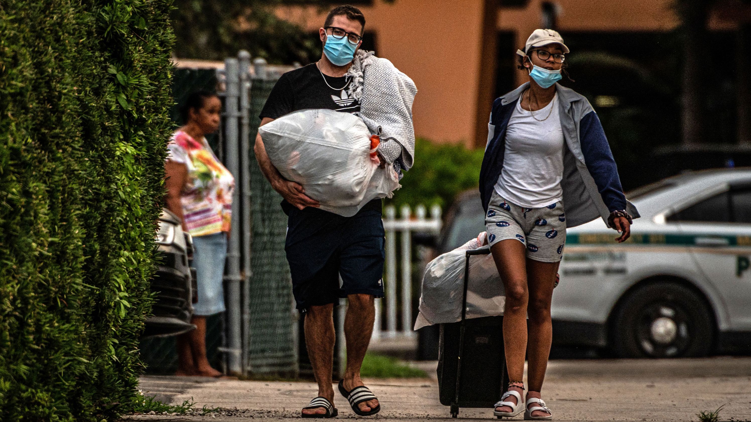 Residents of the Crestview Towers Condominium carry their belongings <a href="https://www.cnn.com/2021/07/02/us/north-miami-crestview-condo-building-ordered-closed/index.html" target="_blank">as they leave their building </a>in North Miami Beach, Florida, on July 2. The building, about 6 miles from Surfside, was deemed to be structurally and electrically unsafe based on a delinquent recertification report for the almost 50-year-old building. The city said the move was out of an "abundance of caution," as area authorities check high-rise condo buildings following the Surfside collapse.