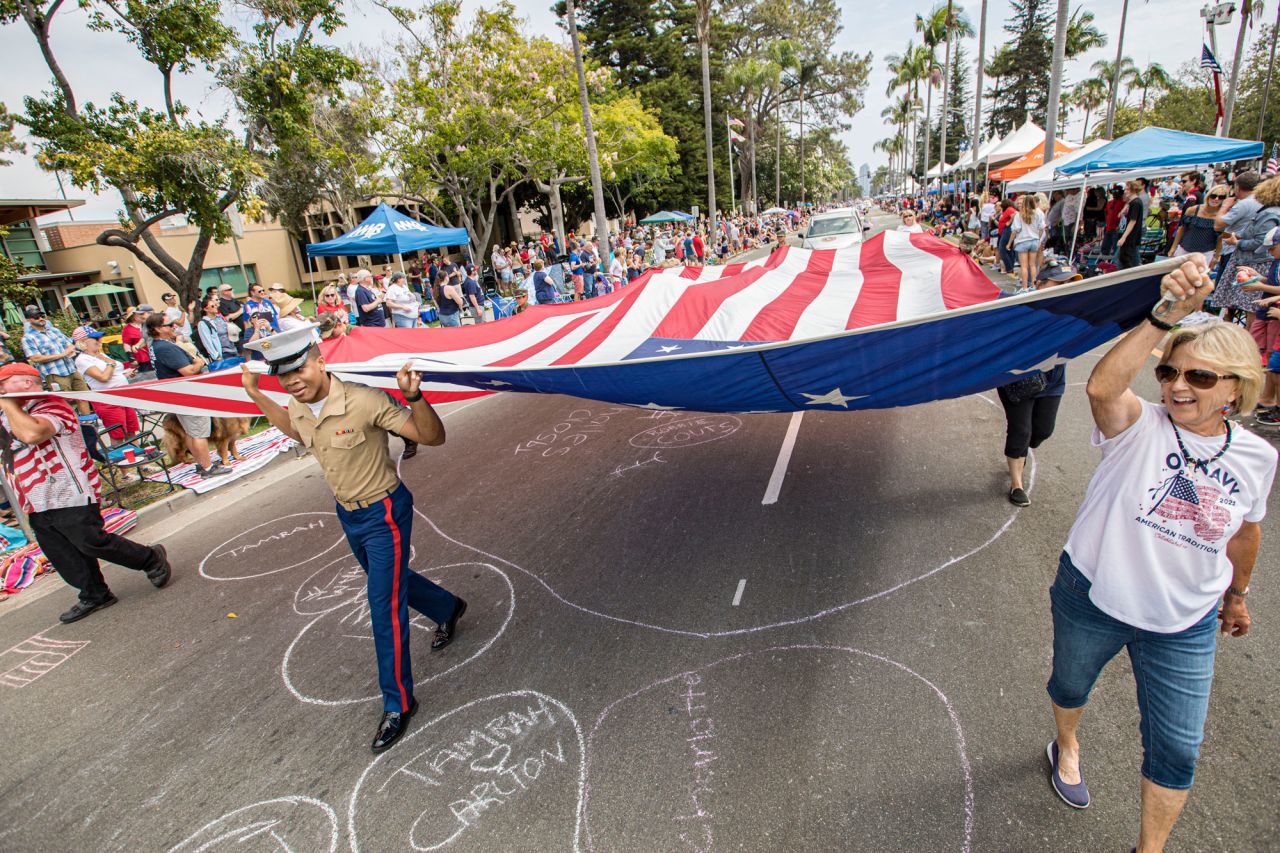People carry an American flag during the Coronado Fourth of July Parade on Saturday, in Coronado, California.