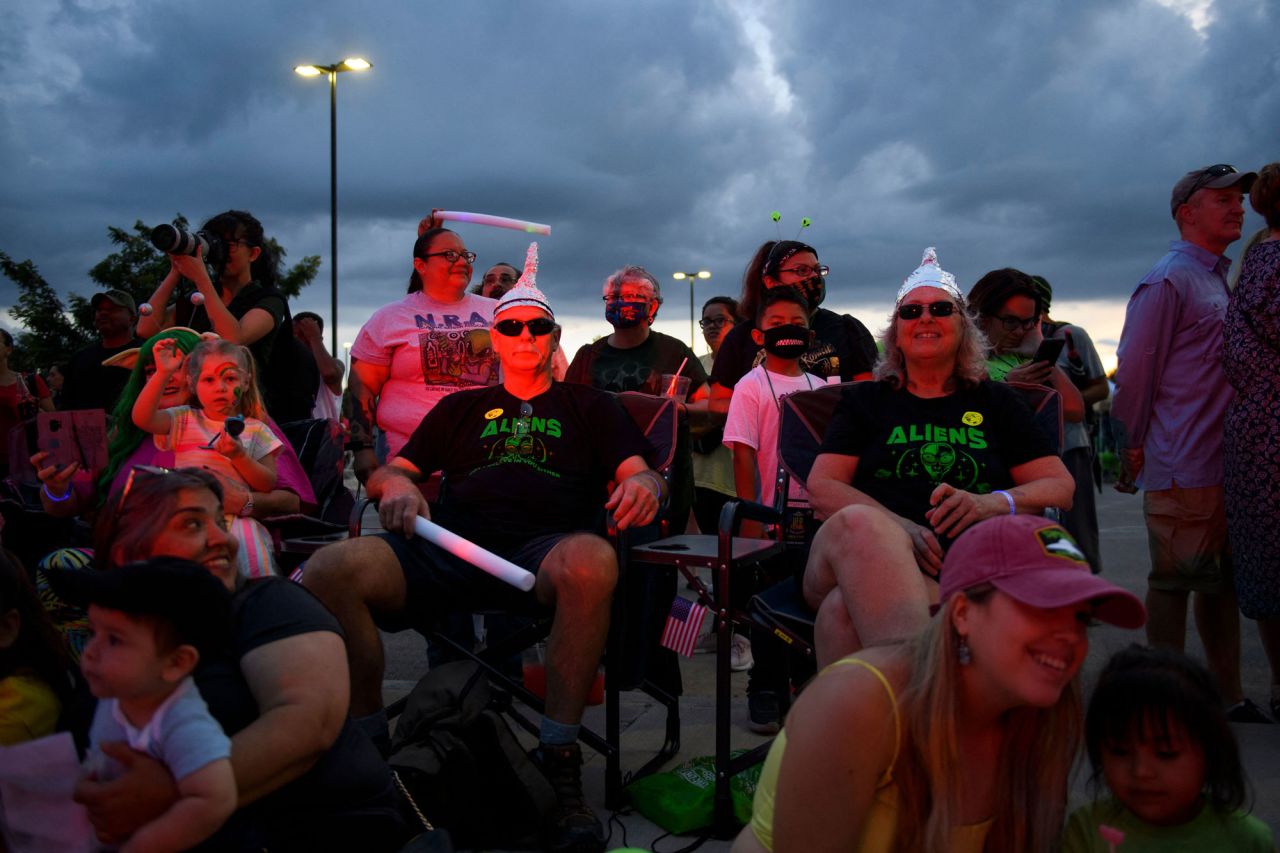 People wearing tin foil hats watch the Abduction parade during the UFO Festival on July 2 in Roswell, New Mexico. The festival returned this year during the July 4th holiday weekend following last year's cancellation due to the pandemic. 