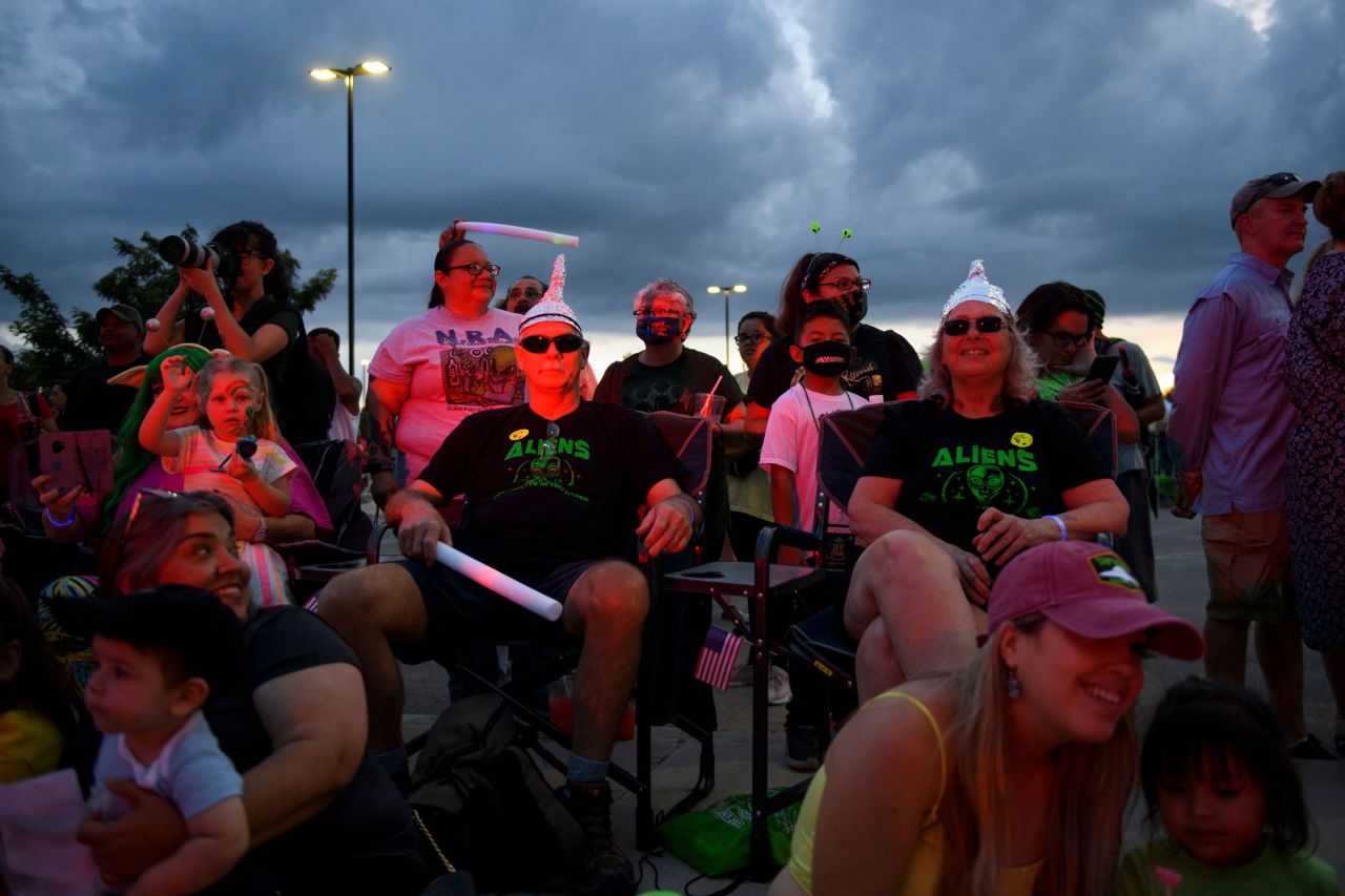 People wearing tin foil hats watch the Abduction parade during the UFO Festival on July 2 in Roswell, New Mexico. The festival returned this year during the July 4th holiday weekend following last year's cancellation due to the pandemic.