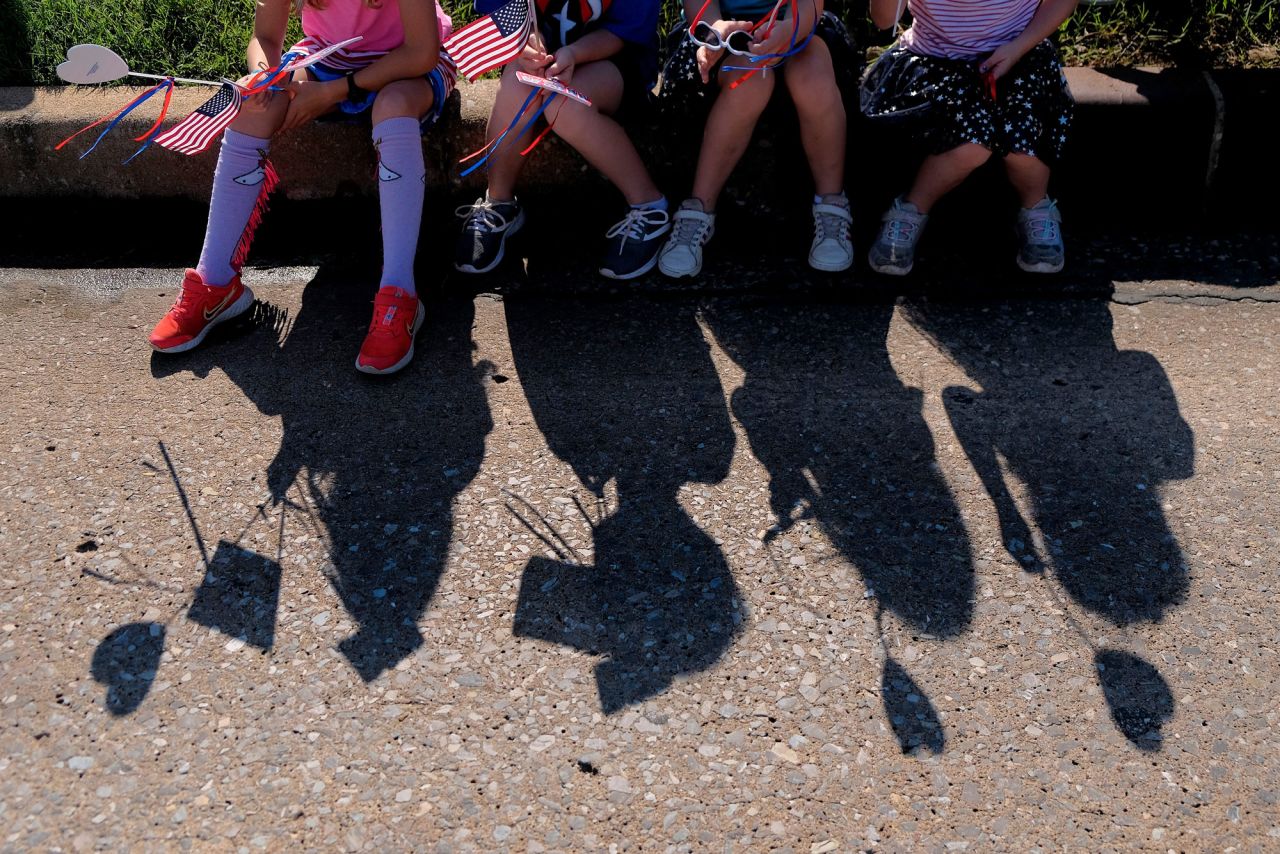 Children watch the LibertyFest Parade in celebration of the Fourth of July in Edmond, Oklahoma, Saturday, July 3.