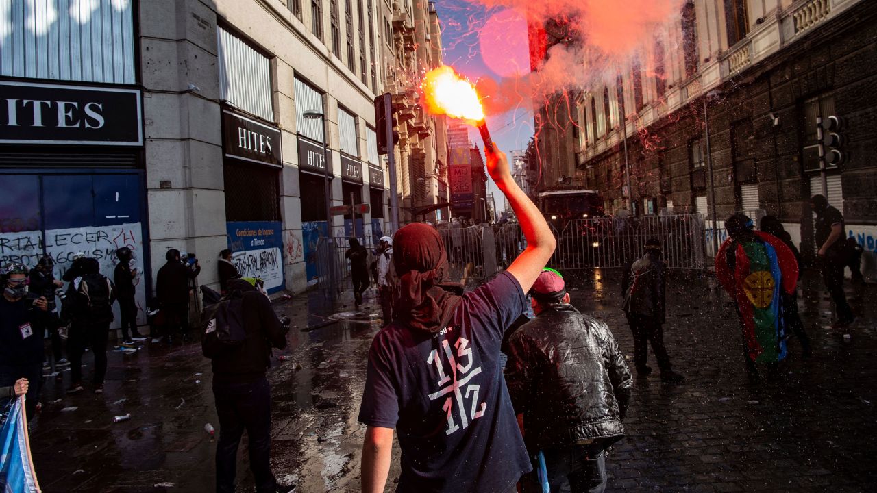 Demonstrator are seen during clashes with riot police near the former Chilean National Congress where Constituent Assembly holds its first session, in Santiago, on July 4, 2021.