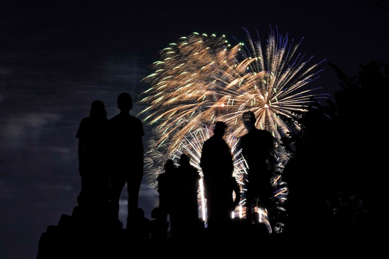 People watch fireworks from a park in Kansas City, Missouri, on Saturday, July 3.