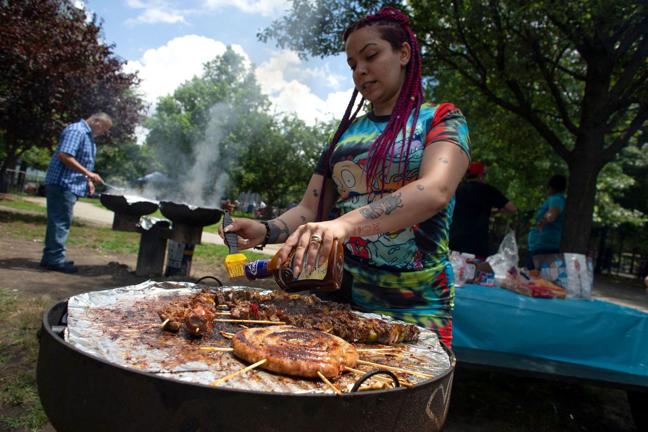 A woman grills food at McCarren Park in New York, on Sunday.