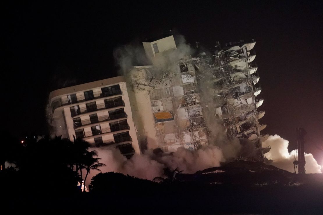 The damaged remaining structure at the Champlain Towers South condo building collapses in a controlled demolition, Sunday in Surfside, Florida.