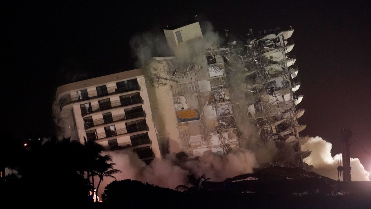 The damaged remaining structure at the Champlain Towers South condo building collapses in a controlled demolition, Sunday in Surfside, Florida.