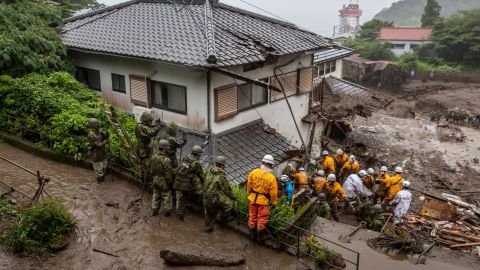Rescue workers search for missing people at the site of a landslide on July 4, 2021 in Atami, Shizuoka, Japan.