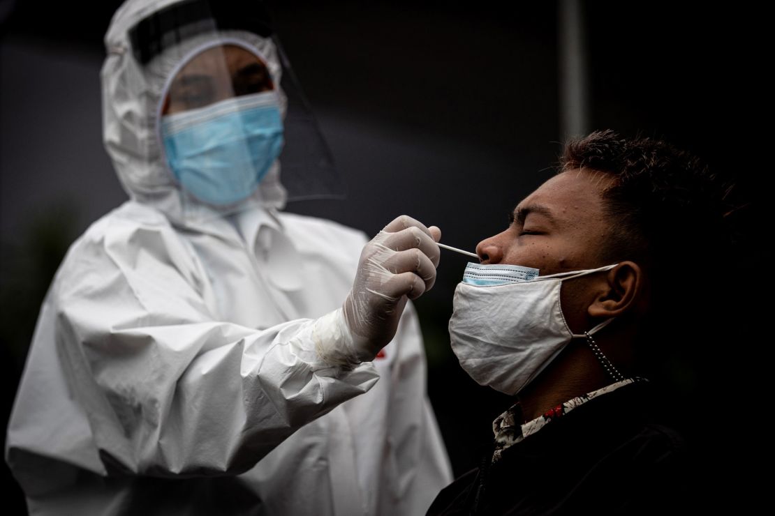 Medical staff take a Covid-19 swab antigen test in Surabaya, Indonesia, on July 3.