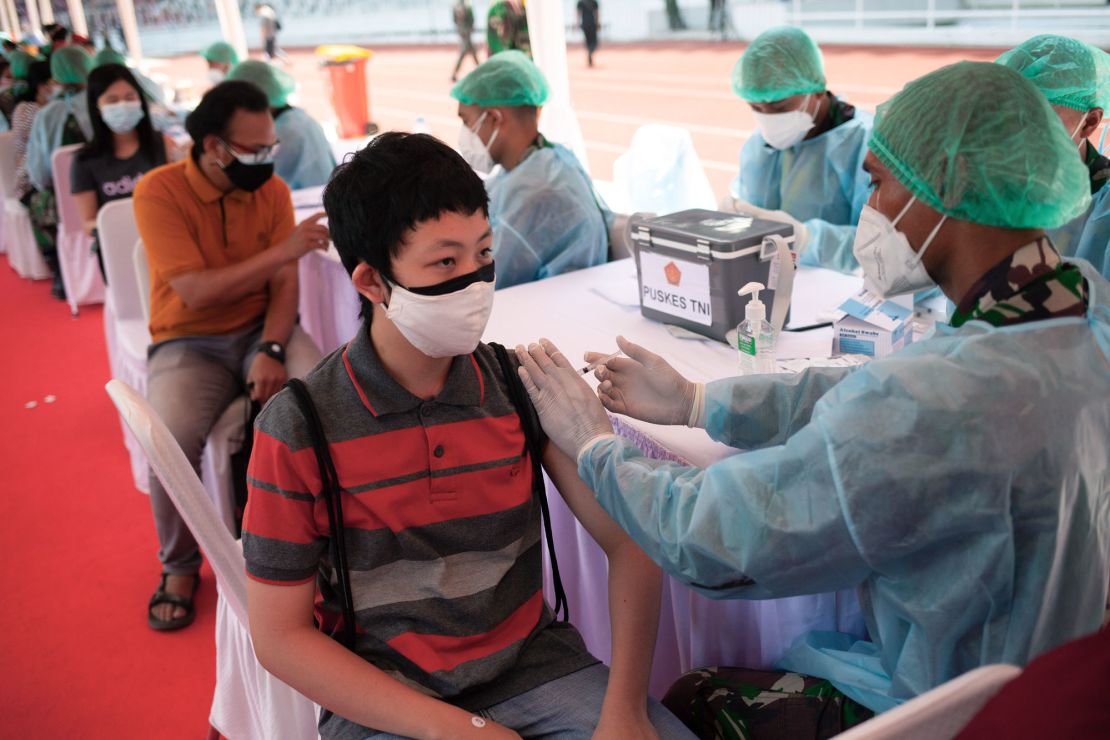 A health worker administers the Sinovac Covid-19 vaccine at the Gelora Bung Karno Stadium in Jakarta, Indonesia. 