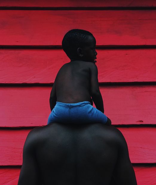 Gyasi focuses on showing children in uplifting and positive situations. One of his early pieces, "Fatherhood," shows a young child sitting on their father's shoulders. 