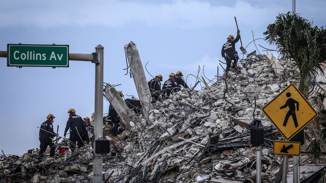 Rescuers search for victims at a collapsed South Florida condo building Monday.