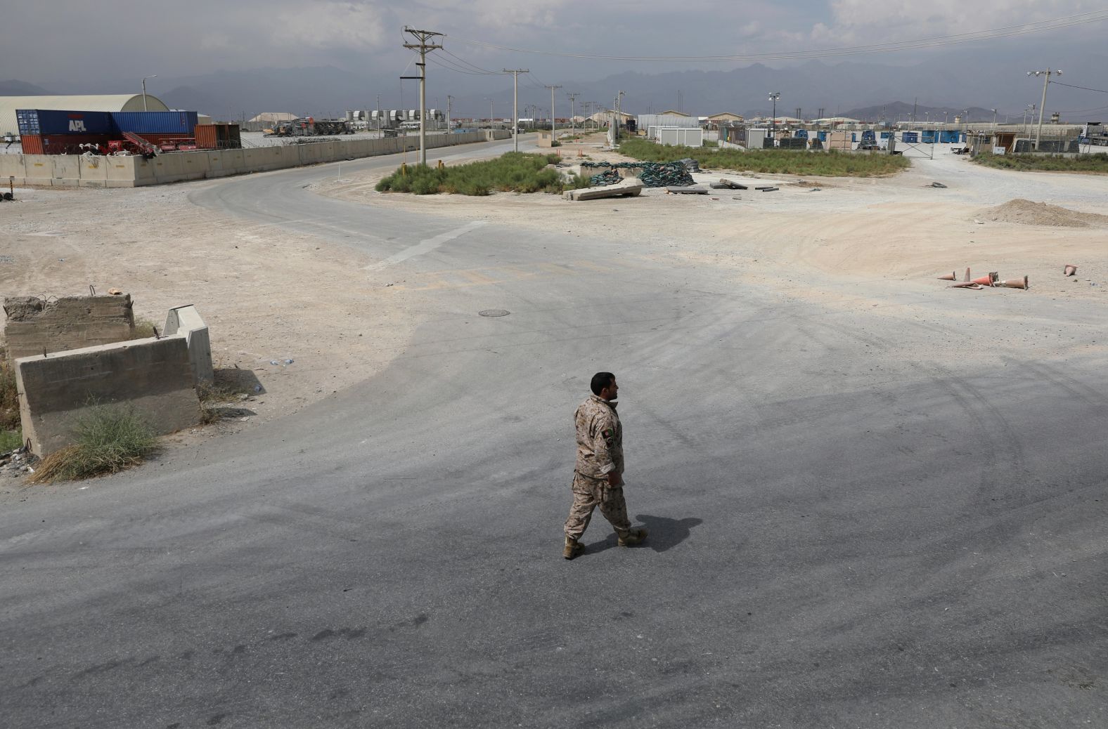 A member of Afghanistan's security forces walks at Bagram Air Base after the last American troops <a href="index.php?page=&url=https%3A%2F%2Fwww.cnn.com%2F2021%2F07%2F01%2Fpolitics%2Fus-military-bagram-airfield-afghanistan%2Findex.html" target="_blank">departed the compound</a> in July 2021. It marked the end of the American presence at a sprawling compound that became the center of military power in Afghanistan.