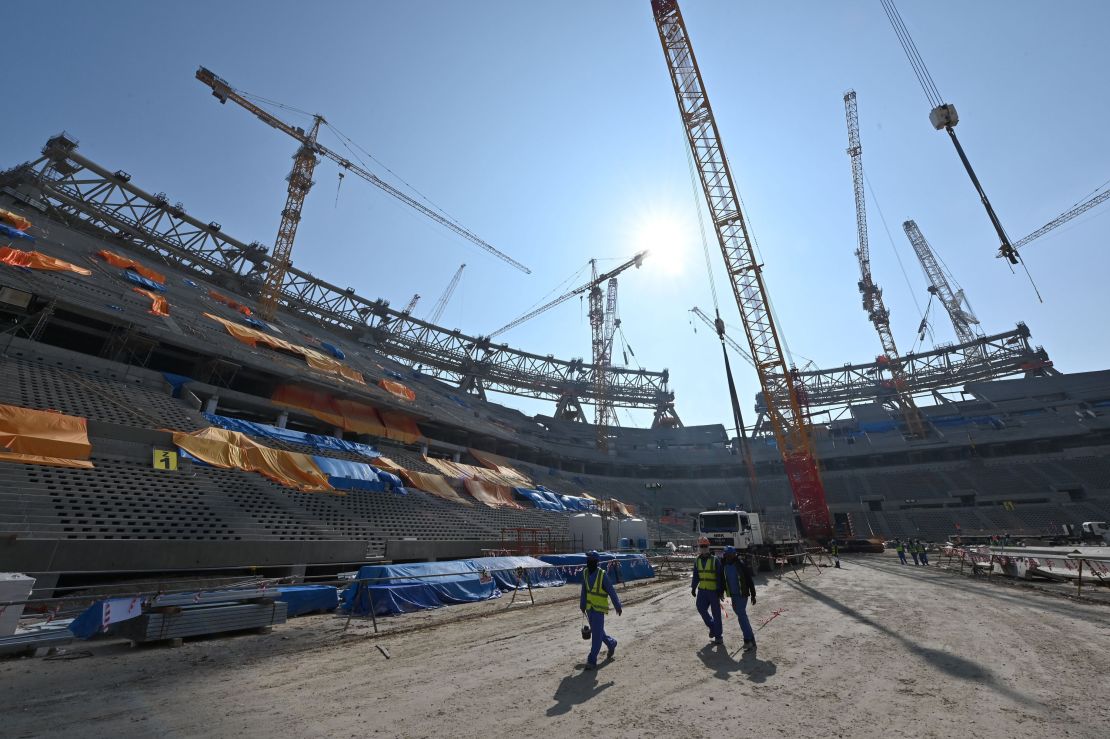 A picture taken on December 20, 2019 shows construction workers at Qatar's Lusail Stadium, around 20 kilometers north of the capital Doha.