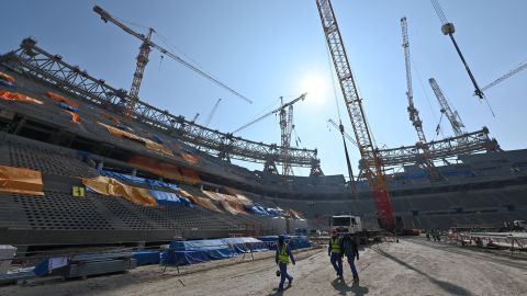 A picture taken on December 20, 2019 shows construction workers at Qatar's Lusail Stadium, around 20 kilometers north of the capital Doha.