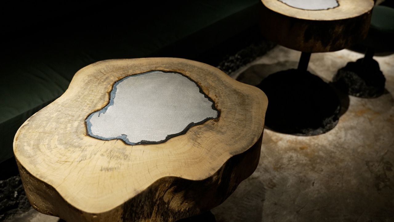 <strong>Turning tables: </strong>Designed by Hong Kong architecture firm <a href="http://www.collective-studio.co/" target="_blank" target="_blank">Collective Studio</a>, the bar's interior is also sustainability-focused, using locally sourced materials. The tables are made from wood salvaged from trees uprooted in Hong Kong by Typhoon Mangkhut in 2018, and topped with recycled aluminum from the city.