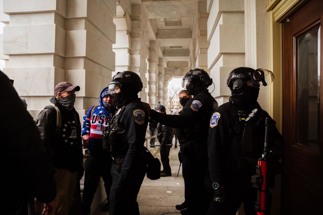 Capitol Police in riot gear face off against a group of pro-Trump protesters after removing them from the Capitol Building on January 6, 2021 in Washington, DC. 