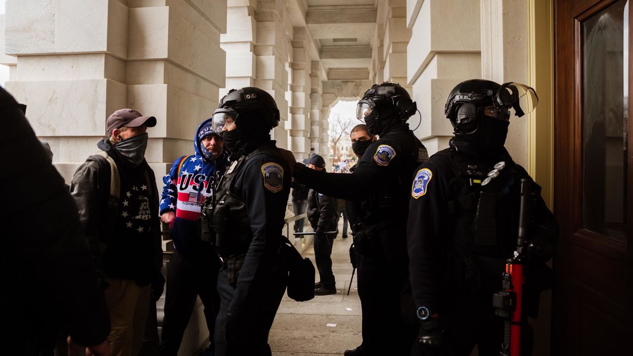 Capitol Police in riot gear face off against a group of pro-Trump protesters after removing them from the Capitol Building on January 6, 2021 in Washington, DC. 