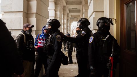 Capitol Police in riot gear face off against a group of pro-Trump protesters after removing them from the Capitol Building on January 6. 